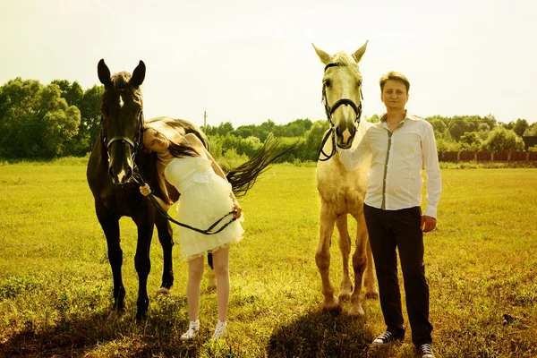 Wedding of unusual couple happy near horses — Stock Photo, Image