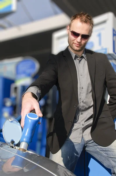 Young man with convertible at gas station — Stock Photo, Image