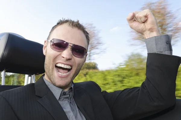 Successful businessman in a convertible — Stock Photo, Image