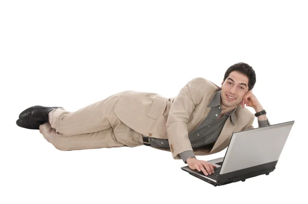 Zakenman met laptop liegen — Stockfoto