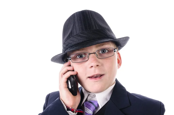 A portrait of a confident little boy in black suit mit telephone — Stock Photo, Image