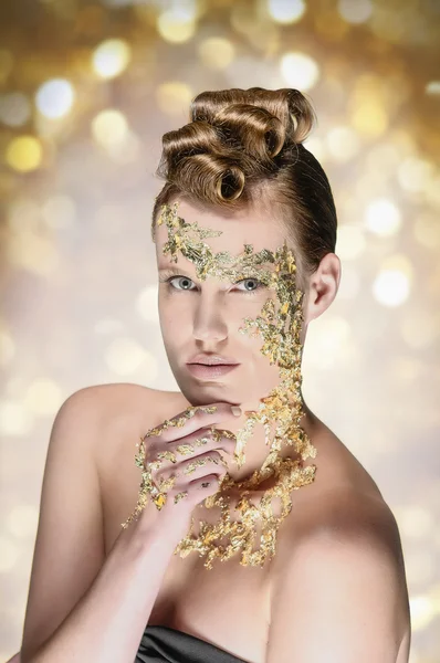 Attractive woman with gold makeup and bokeh — Stock Photo, Image