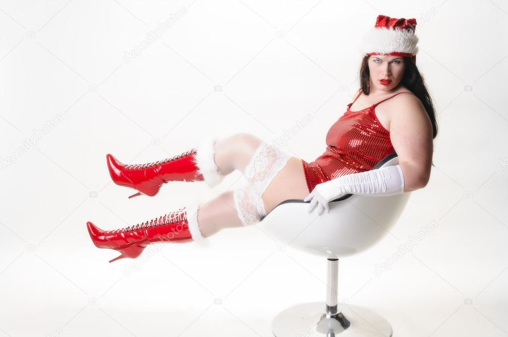 Sexy christmas woman in armchair