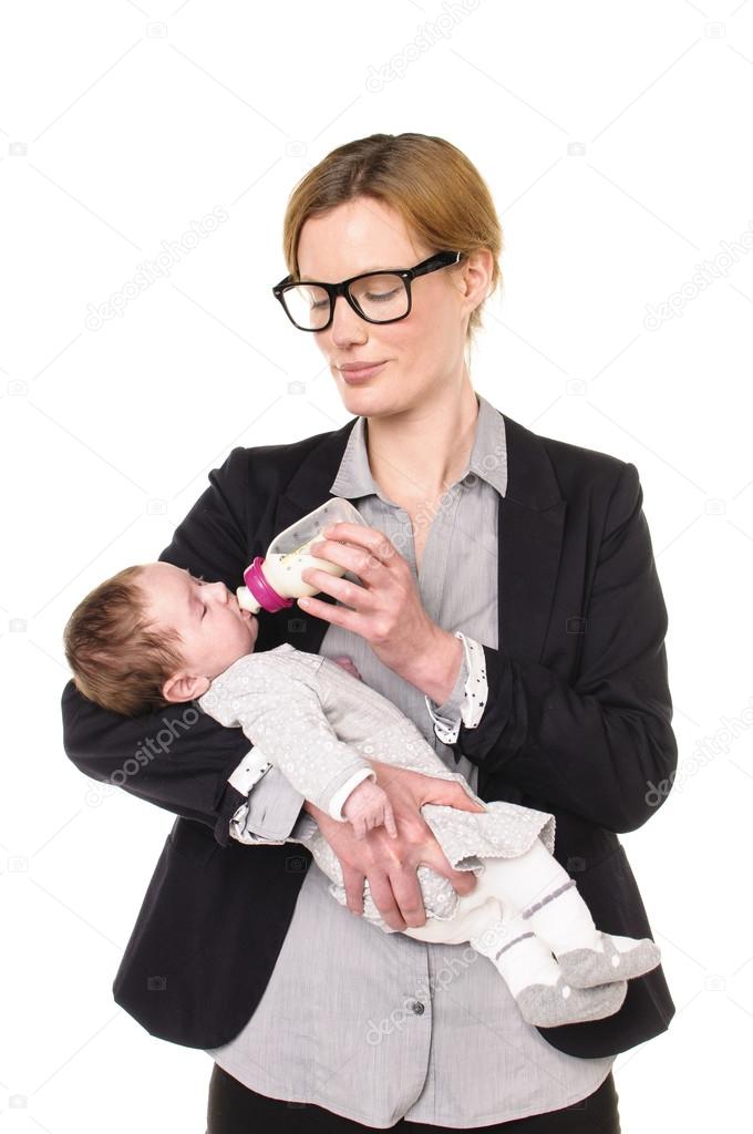Businesswoman gives a baby the bottle