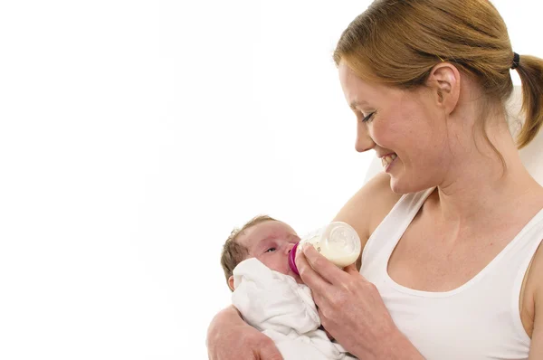 Giving mother with infant, bottle — Stock Photo, Image