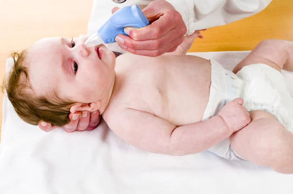 Baby with nose cleaner — Stock Photo, Image