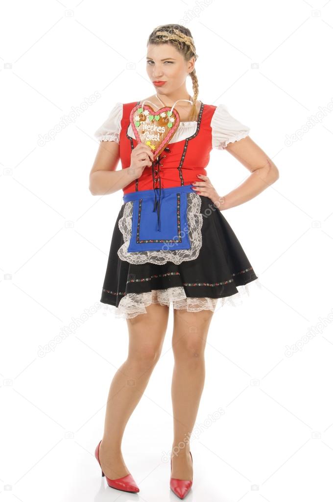 Oktoberfest, blond young woman holding gingerbread heart