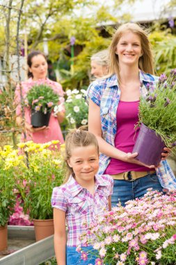 Garden center woman with girl buying flowers
