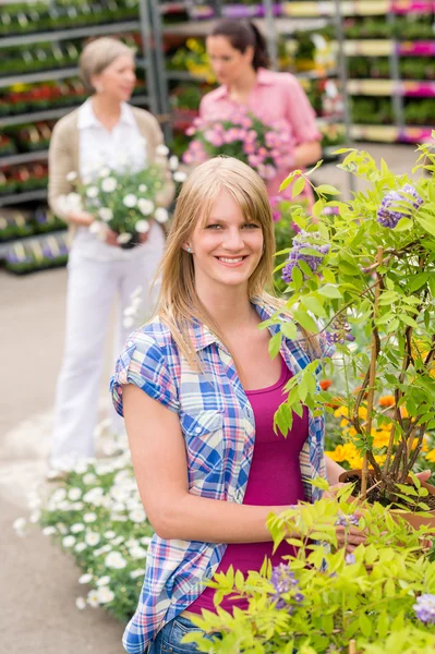 Woman hold tree plant at garden center Royalty Free Stock Photos