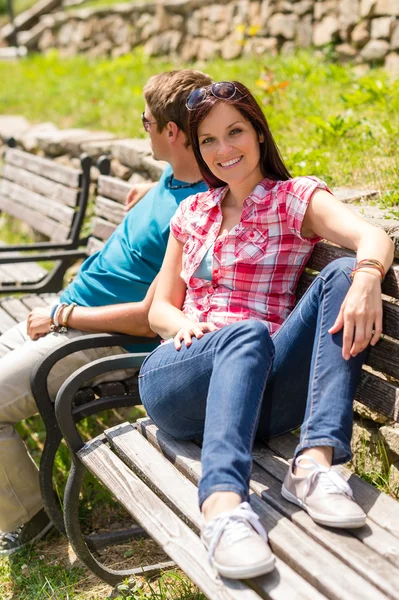 Jong stel zittend op bank in park — Stockfoto