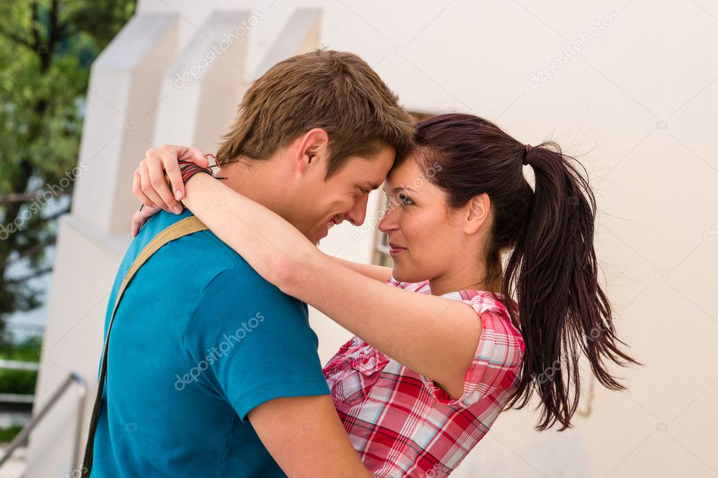 Happy dating couple embracing outdoors