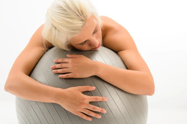 Tired sportive woman resting on fitness ball — Stock Photo, Image