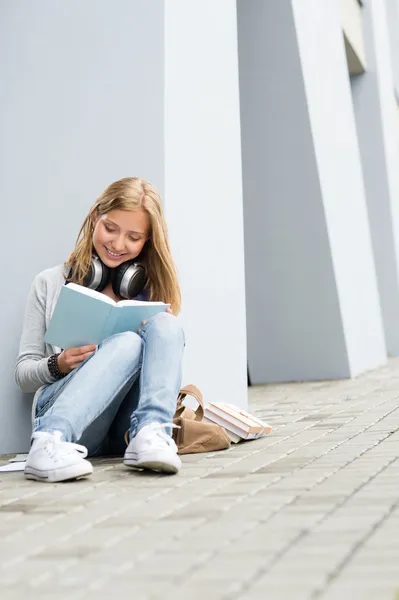 微笑着的年轻研究女人读本书户外 — 图库照片