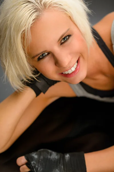 Female kickboxer in black relax lying down Stock Picture