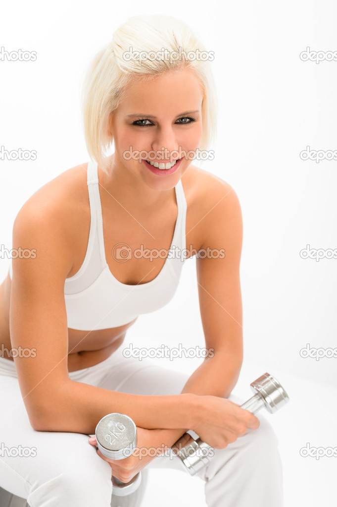 Fitness woman hold weights sit gym ball