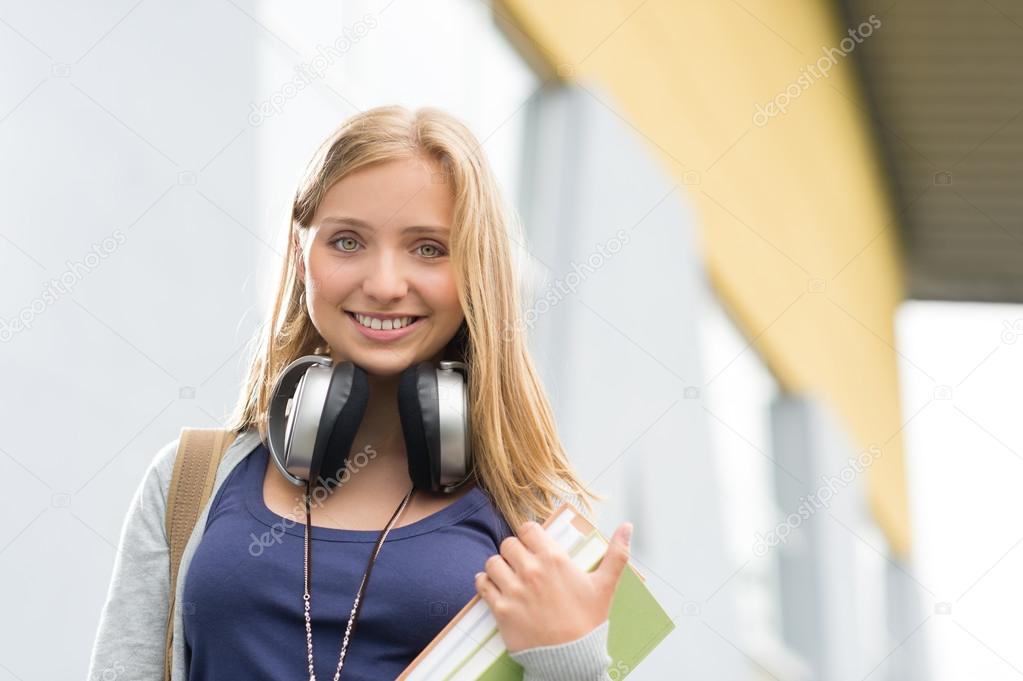 Student girl with headphones smiling at camera