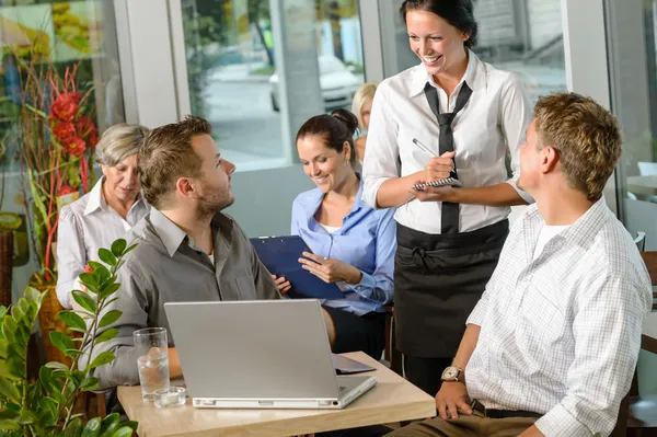 Waitress taking order from businessmen in cafe — Stock Photo, Image