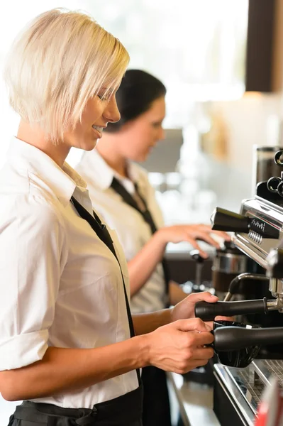 Waitresses at work make coffee machine cafe Royalty Free Stock Images