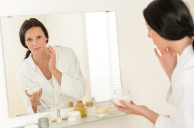 Woman facial mirror reflection in bathroom clipart