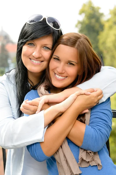 Teen and her mother embracing outdoors bonding Royalty Free Stock Images