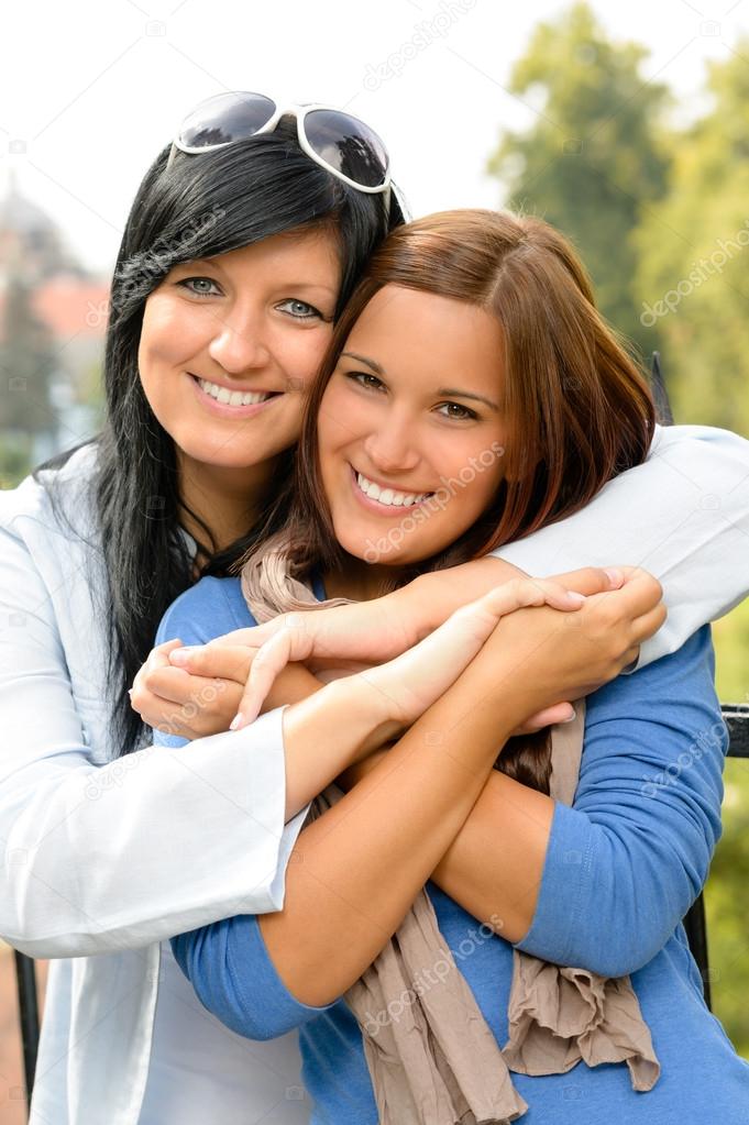 Teen and her mother embracing outdoors bonding