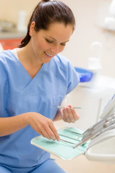 Female dentist with dental equipment at surgery Royalty Free Stock Images
