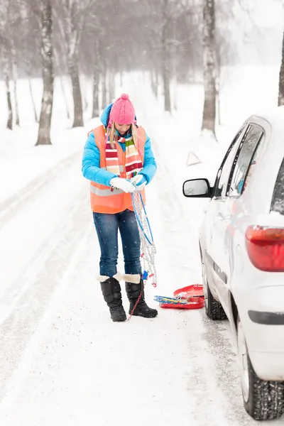 Woman holding car chains winter tire snow Stock Image