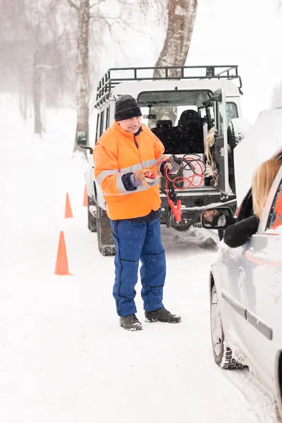 Man helping woman with broken car snow Stock Photo