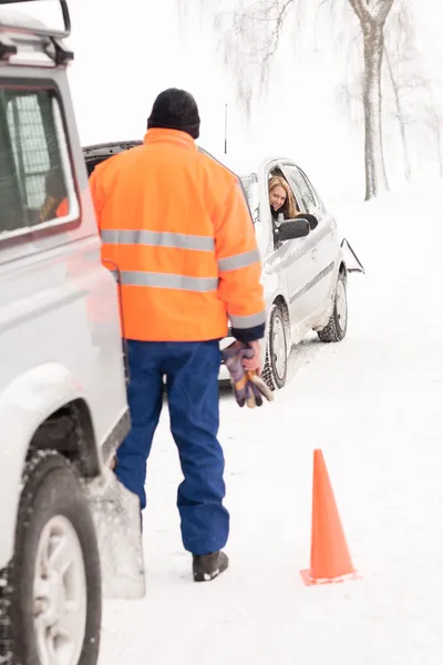 Man helping woman car breakdown assistance snow Stock Photo