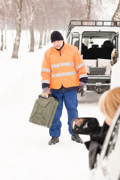 Woman broken car man gas can snow Stock Picture