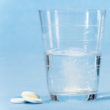 Fizzy vitamini kapsülü su bardağına atmak