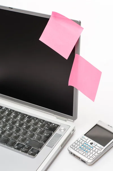 Post-it stickers on business laptop and phone — Stock Photo, Image