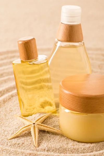 Summer care body product on sand seashell — Stock Photo, Image