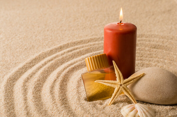 Spa setting candle with oil seashell star