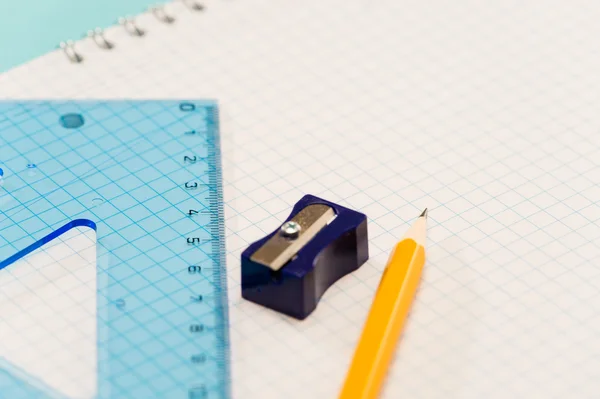 Sharpener with ruler pencil on notepad — Stock Photo, Image