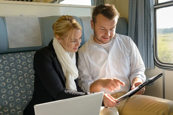 Appunti per laptop donna e uomo in treno — Foto Stock