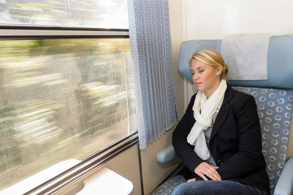 Woman asleep in train compartment tired resting — Stock Photo, Image