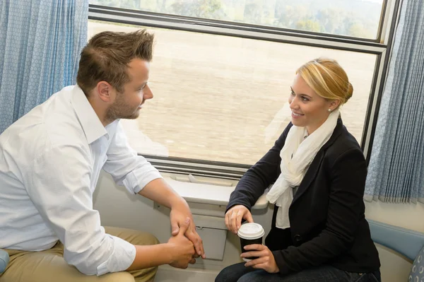 Woman and man traveling with train talking — Stockfoto