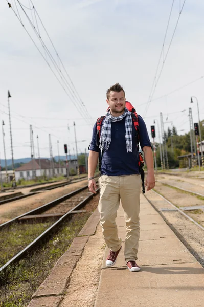 Homem caminhando em direção à estação ferroviária mochila viagem — Fotografia de Stock