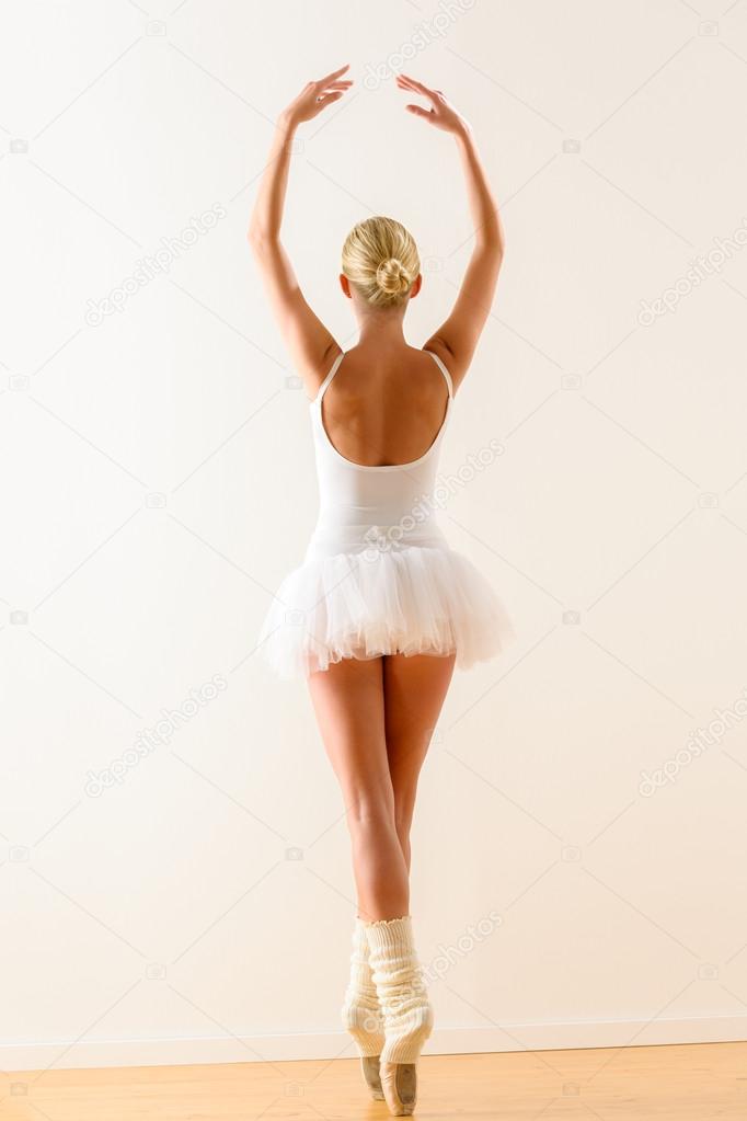 Ballerina pose from behind dancing in studio