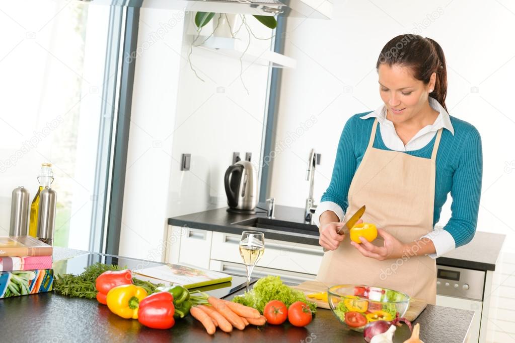 Young woman cutting vegetables kitchen preparing