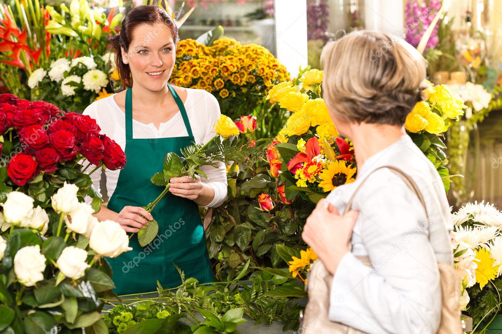 Young woman arranging flowers shop market selling