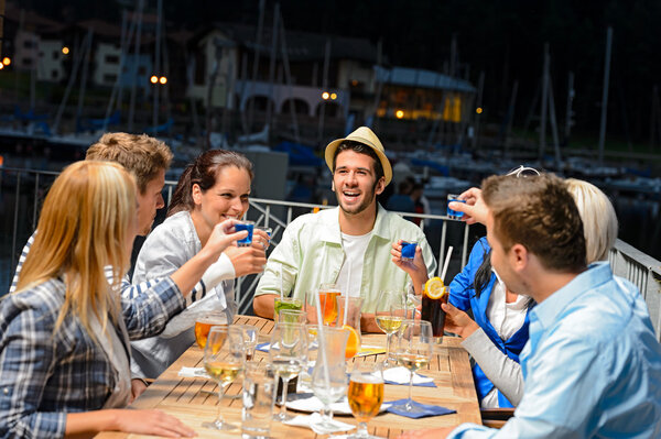 Young doing shots at outside bar