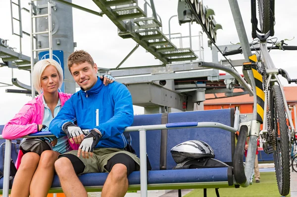 Young couple sitting chair lift waiting departing — Stock Photo, Image