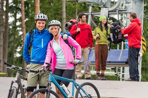 Mountain bikes couple and hikers after chair lift — Stock Photo, Image