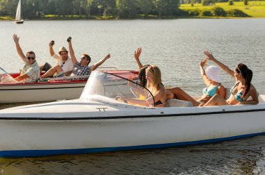 Waving friends sitting in motorboats summertime clipart
