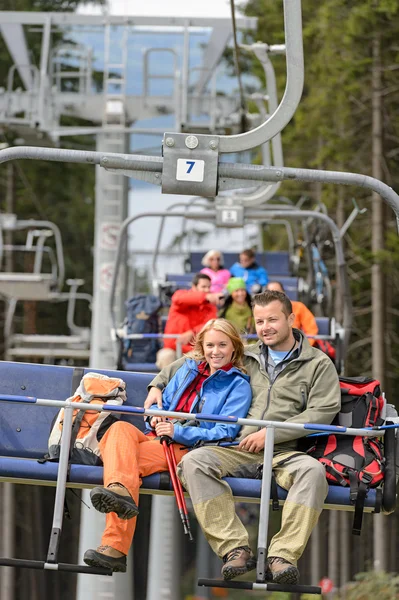 Lovely couple sitting on chairlift — Stock Photo, Image