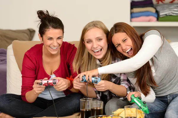 Laughing young girls playing with video games — Stock Photo, Image