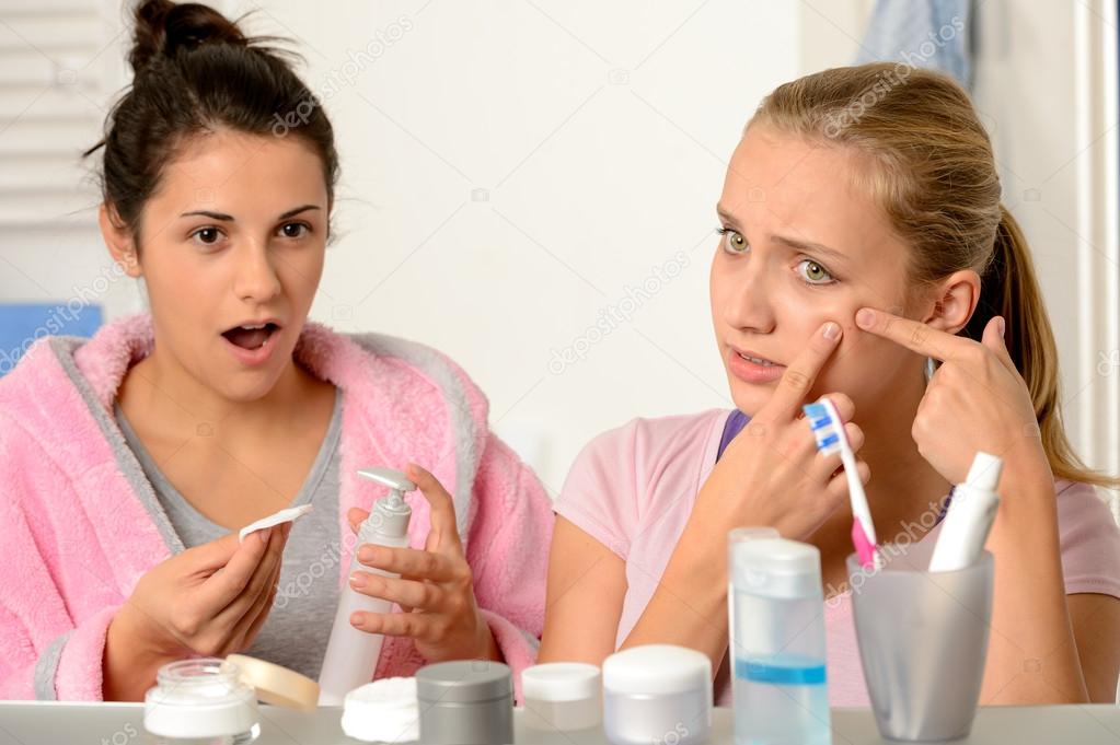Young teenagers with acne problem in bathroom