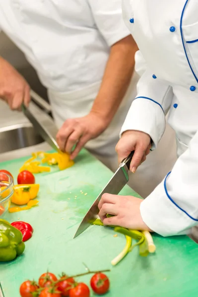 Close up of chefs cutting vegetables — Stock Photo, Image